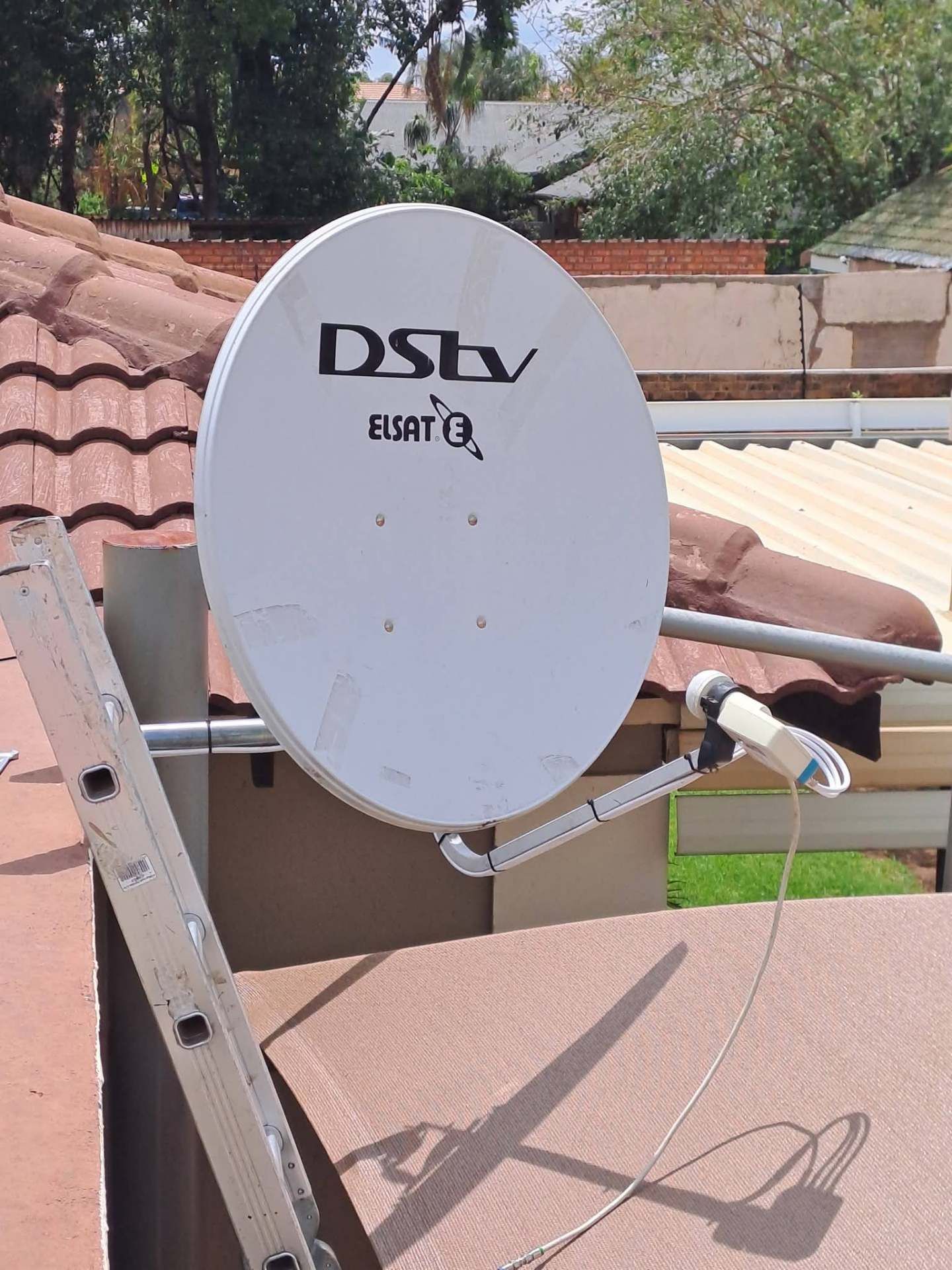 Sandton DStv satellite dish installation Sandton DStv installers and repairs - DStv satellite dish installed on tiled roof